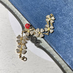 Gold-tone ladybug and clover charm bracelet with rose-like center charm and clasp