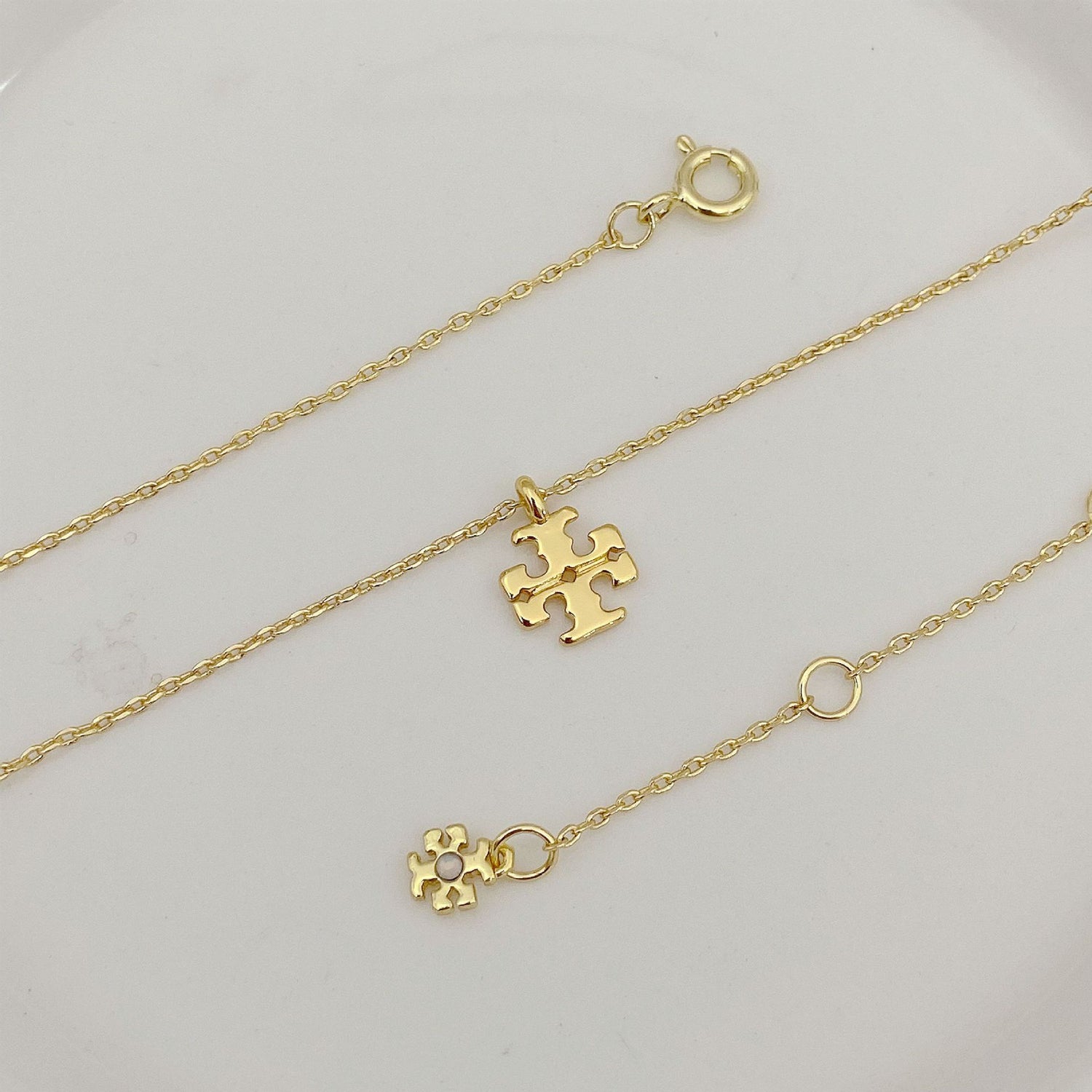 Gold logo pendant necklace set with jigsaw charms and ring clasps