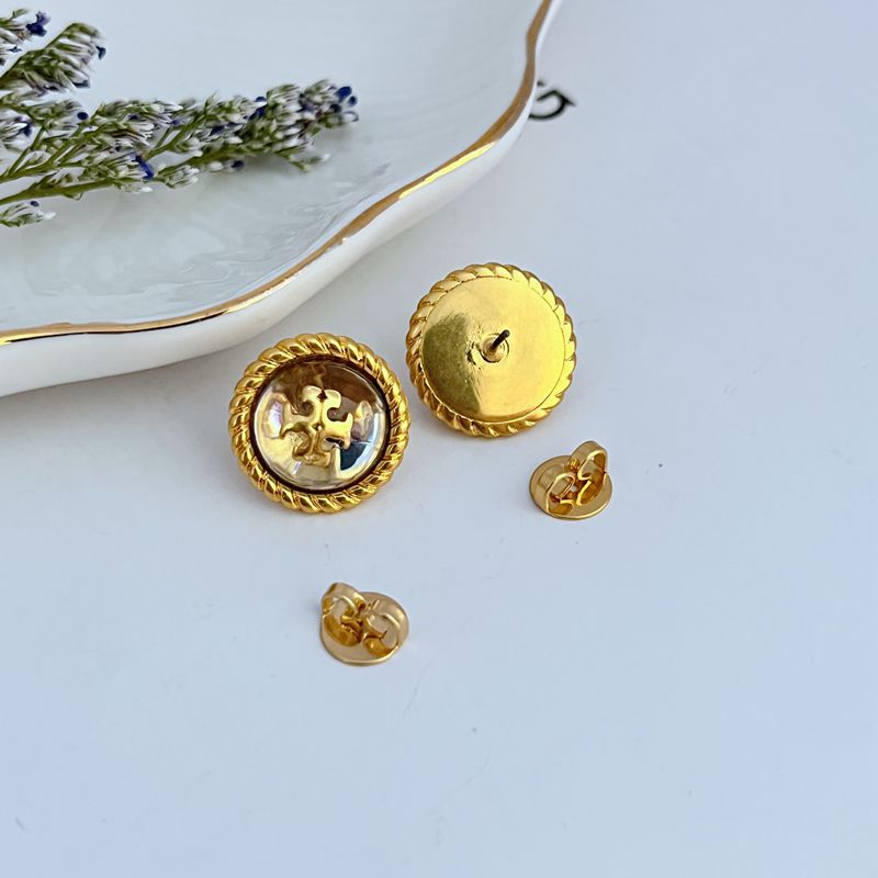 Round metal stud earrings: gold back posts with front white resin logo face