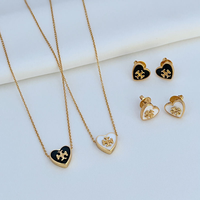 Two gold-tone heart necklaces and heart stud earrings with enamel logo, black & white