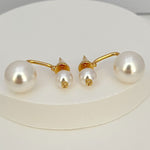 Gold-tone pearl earrings with large and small white pearls on hook