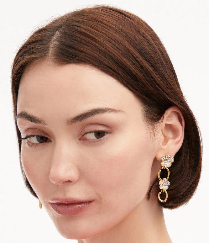 Diamond floral drop earrings with clear crystals, gold clover charms, and oval links