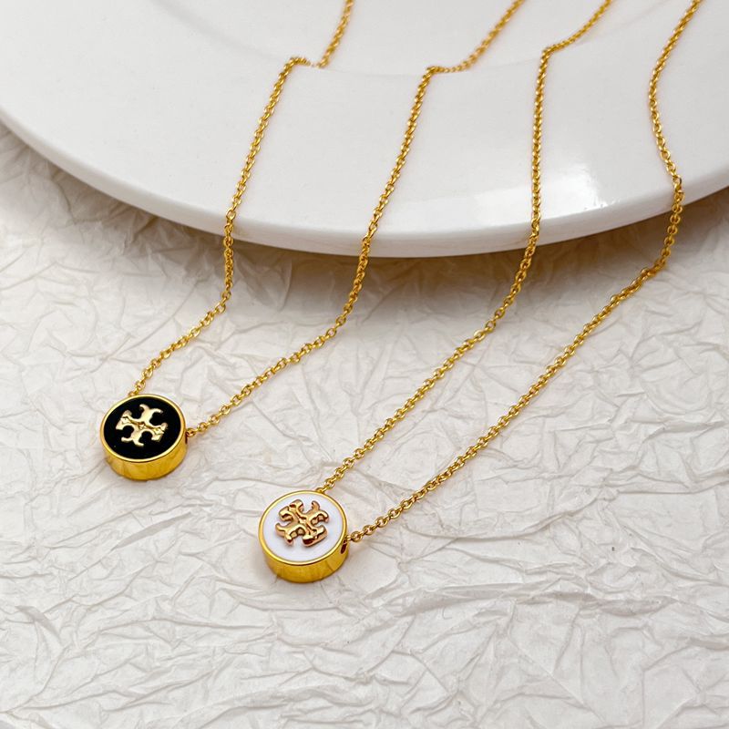Gold-tone layered charm necklace with two round enamel medallions and long chains
