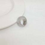 Silver-tone ring, side view with continuous rhinestone band around the top