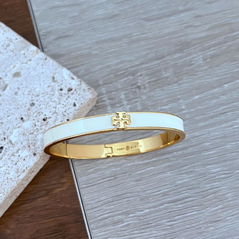 Enamel logo bracelet with gold-tone hardware, light blue enamel band