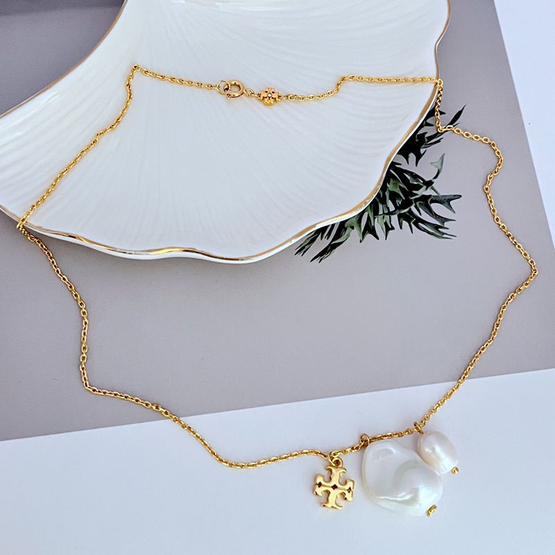 Baroque pearl logo pendant necklace with gold-tone chain and small charm detail
