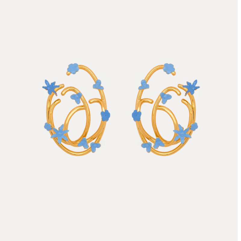 Blue enamel geometric hoop earrings with small star and flower motifs