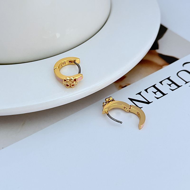 Geometric enamel hoop earrings, gold-tone with pink enamel and charm detail