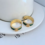 Gold-tone enamel hoop earrings with green round band and gold emblem front