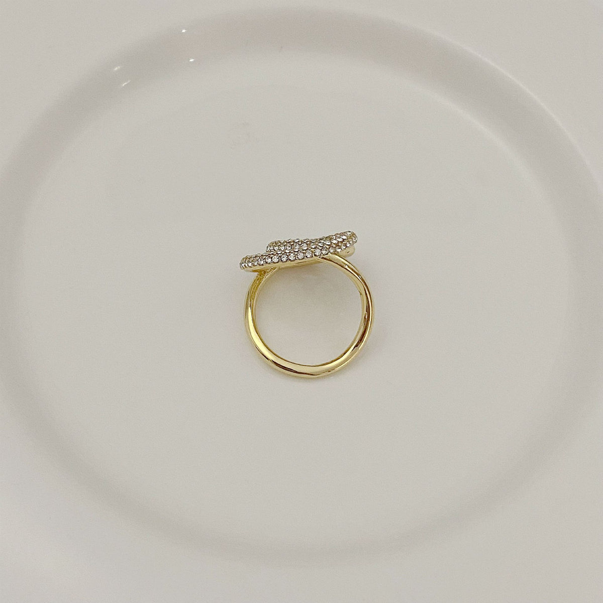 Gold-tone ring with pavé crystal double-loop design