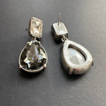 Teardrop-cut diamond stud earrings in silver-tone with clear and dark stones, post backs