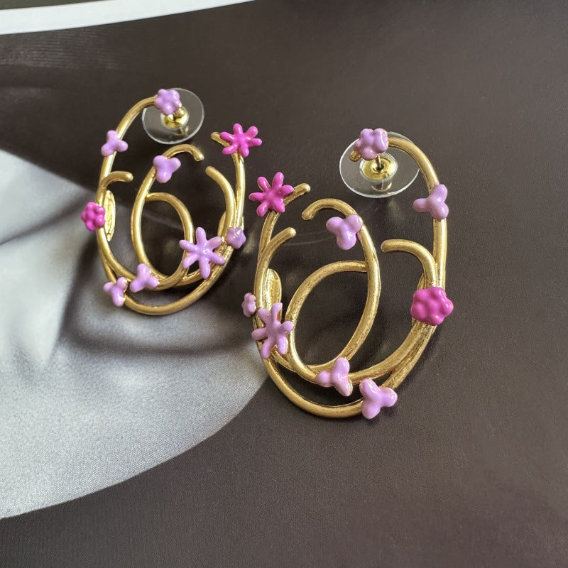 Pink enamel geometric hoop earrings with clover and star charms