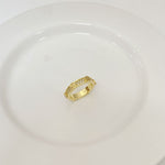 Gold-tone rhinestone band ring with round top stones, openwork pattern