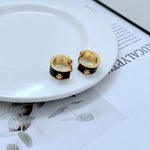 Gold-tone enamel geometric hoop earrings, black with gold trim