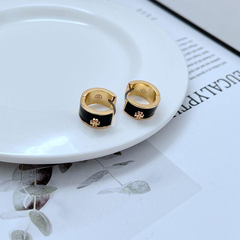 Gold-tone geometric hoop earrings with black enamel accents, hinged clasp back.