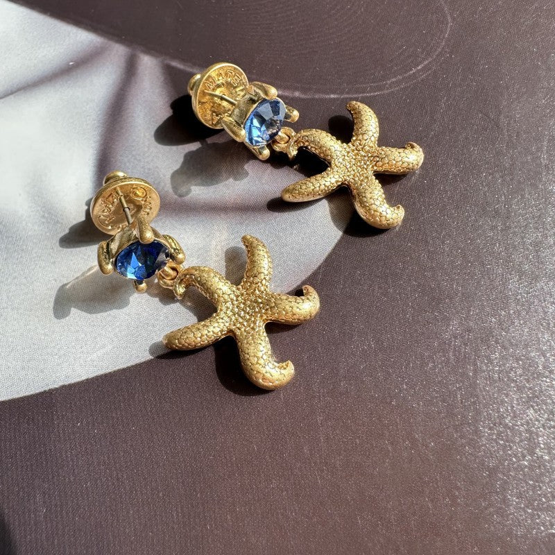 Oscar de la Renta vintage gold starfish stud earrings with blue crystals