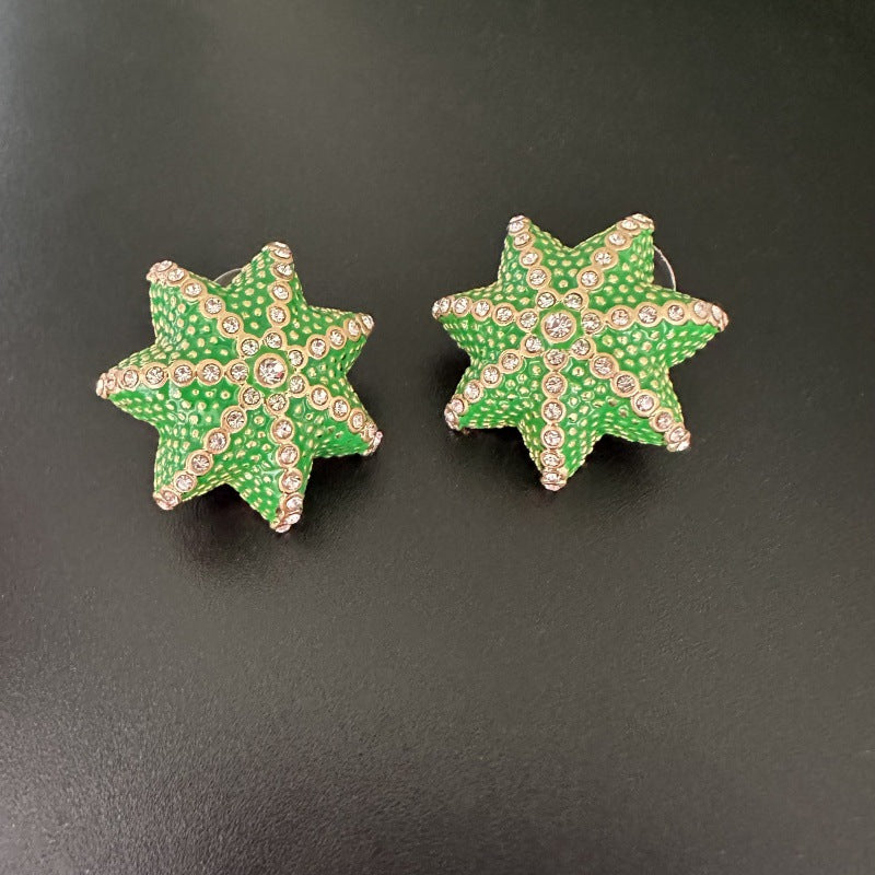 Oscar de la Renta green star stud earrings with clear rhinestone details
