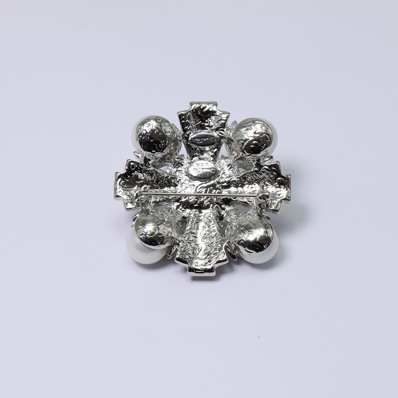 Silver-tone pearl and crystal brooch back, textured metal prongs and frame