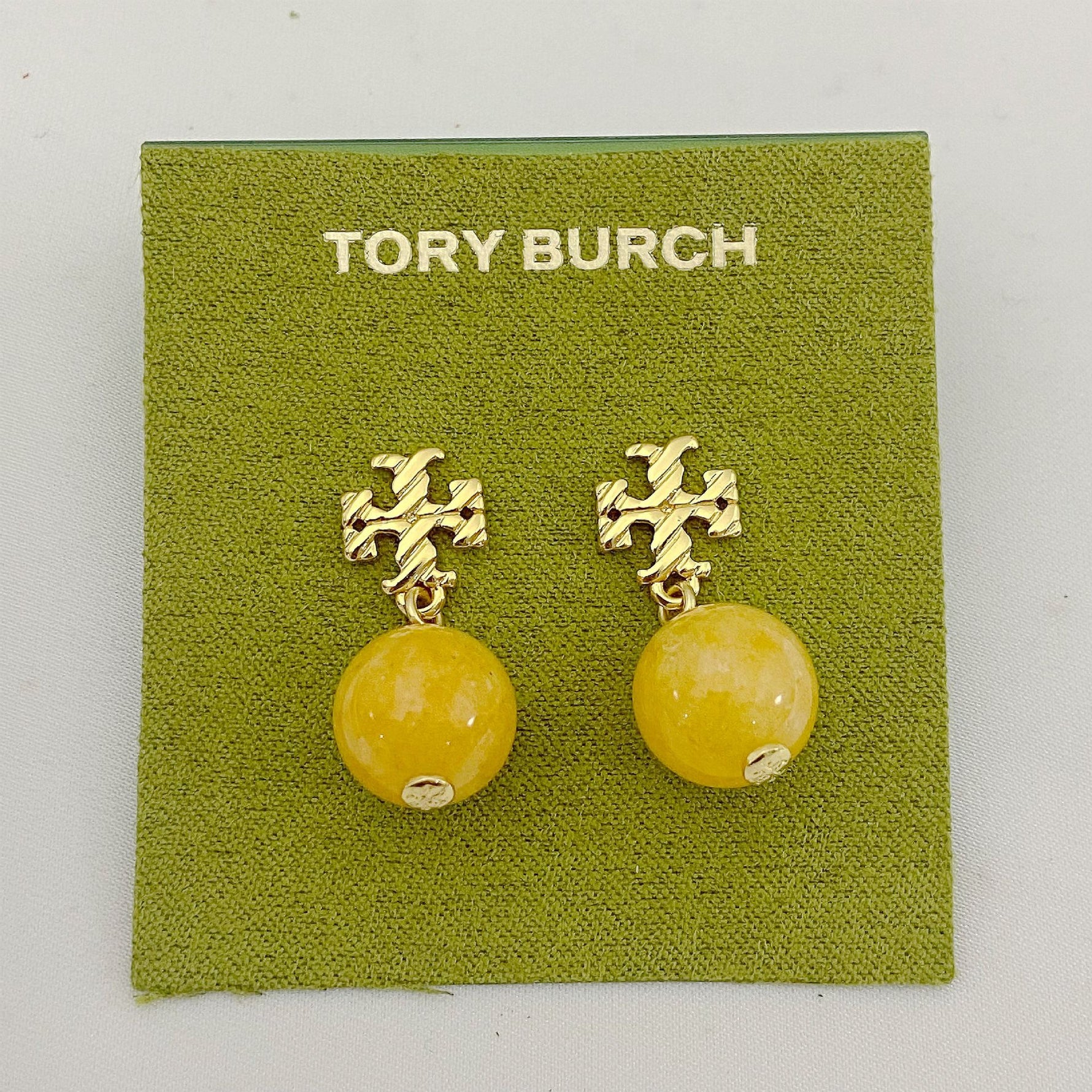 Yellow agate pendant earrings with gold logo stud and round bead drop
