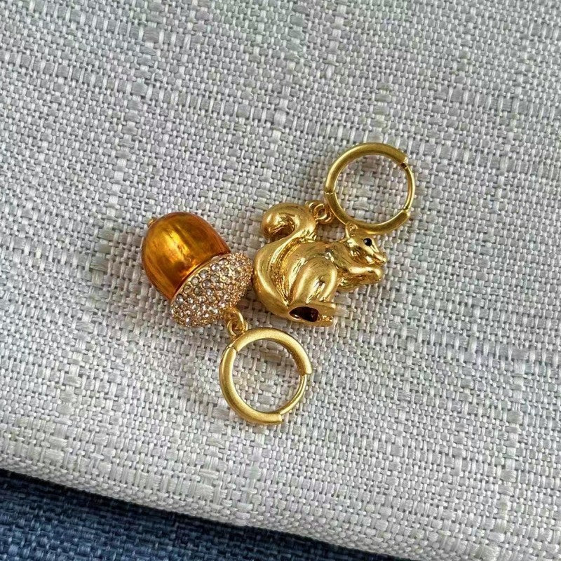 Gold-tone squirrel and acorn charm earrings with hoop loops and sparkle details