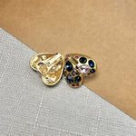 Heart-shaped crystal stud earrings, gold tone; side view shows butterfly back and stones