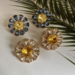 Sunburst flower stud earrings with blue teardrop stones and pale yellow center