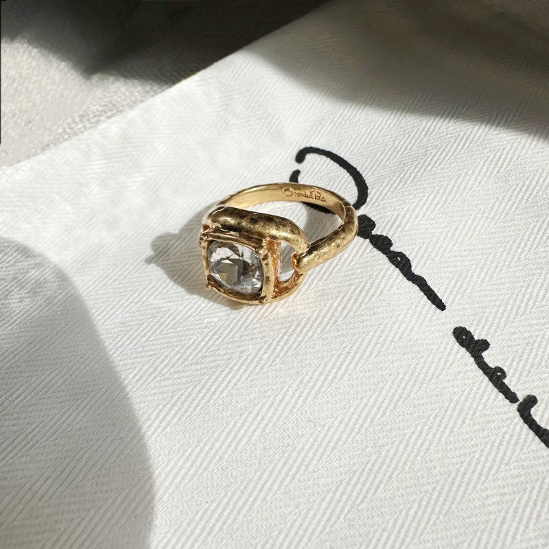 Gold square ring with clear stone and textured band, stamped inside