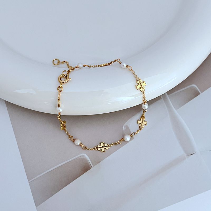 Perlen-Logo Armband mit goldfarbener Kette und weißen Süßwasserperlen