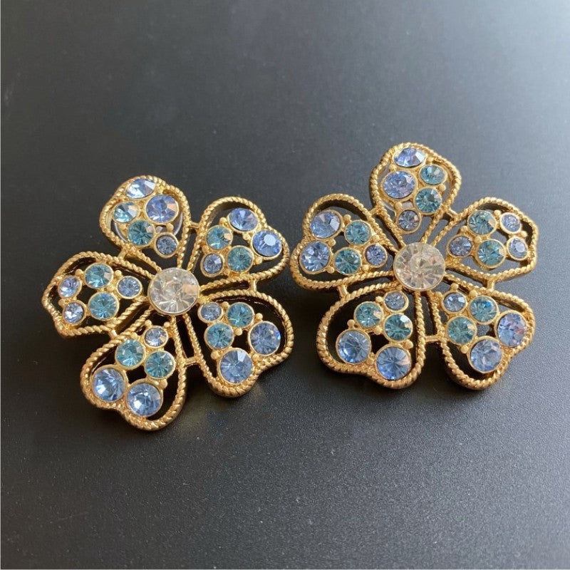 Pavé openwork floral stud earrings, blue stones with round clear center