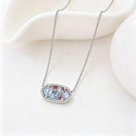 Silver-tone oval USA letter pendant necklace with blue enamel border