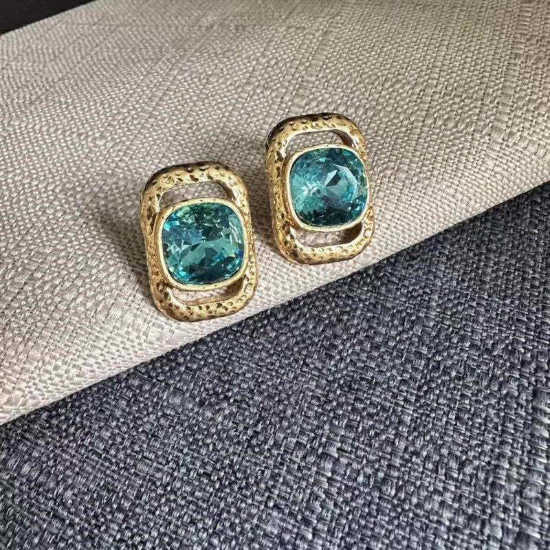 Square crystal stud earrings with light-blue square stones in gold-tone frames