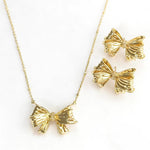 Gold bow pendant necklace and matching bow stud earrings