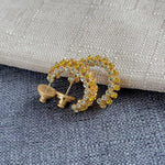 Gold-tone cubic zirconia C-hoop earrings with yellow and clear stones; stud backs