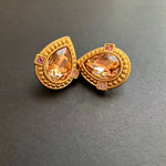 Gold-tone heart-shaped crystal clip-on stud earrings with amber center stones and pink accents