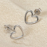 Heart-shaped stud earrings, silver tone, hollow heart outline, butterfly backs