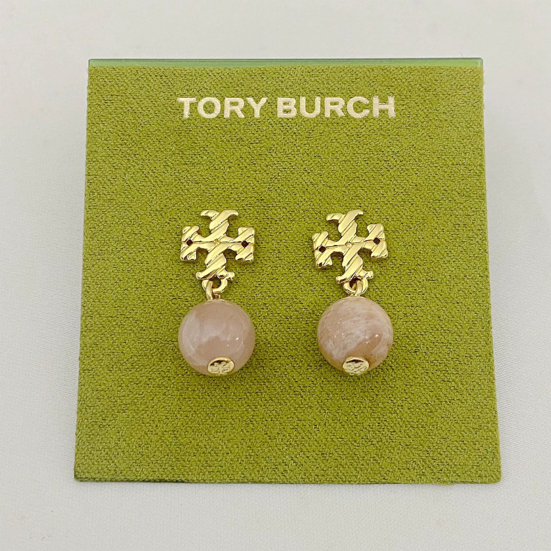 Rose quartz–tone round agate pendant earrings with gold-tone geometric drop details