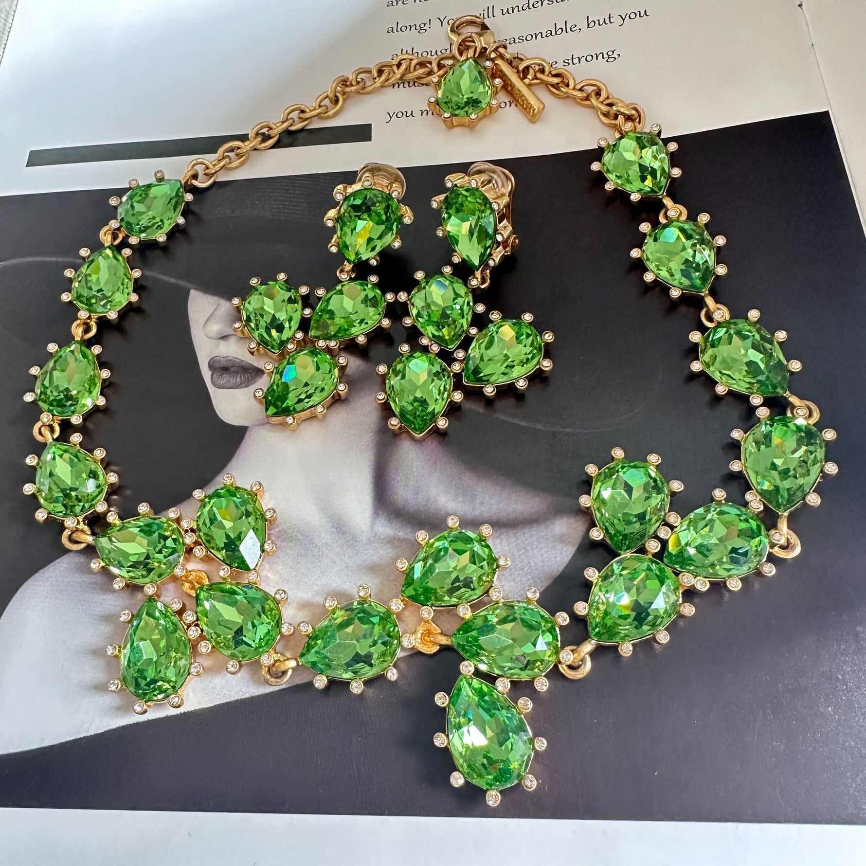 Gold-tone link crystal necklace with green oval faceted stones and clusters