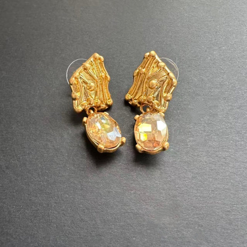 Gold-tone crystal drop earrings with oval golden stones