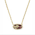 Elisa bow pendant necklace with deep red center stone, gold chain and pavé edge