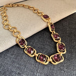 Gold link necklace with purple faceted crystal oval stations