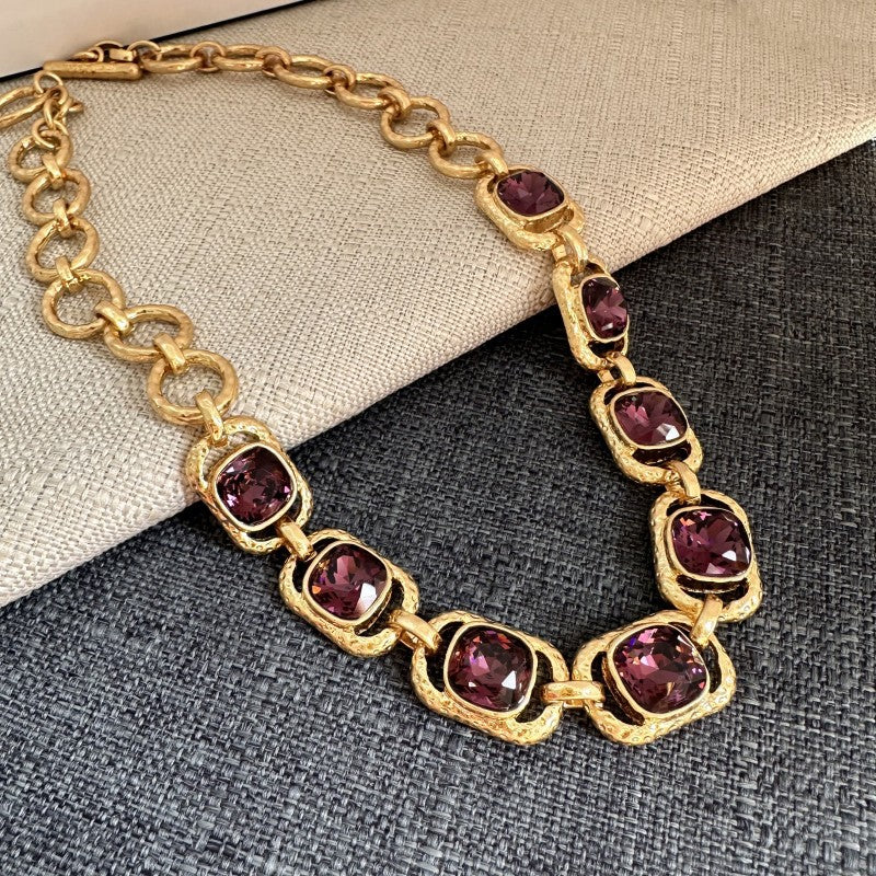 Gold link necklace with purple faceted crystal oval stations