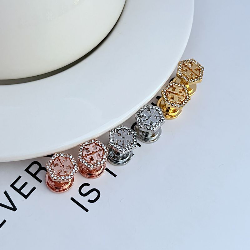 Hexagonal openwork stud earrings in gold and white gold tones with pavé stones