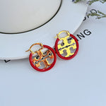 Red enamel circular logo hoop earrings with gold-tone openwork metal inlay