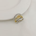 Two-tone three-band metal ring: gold interior, silver pavé outer band