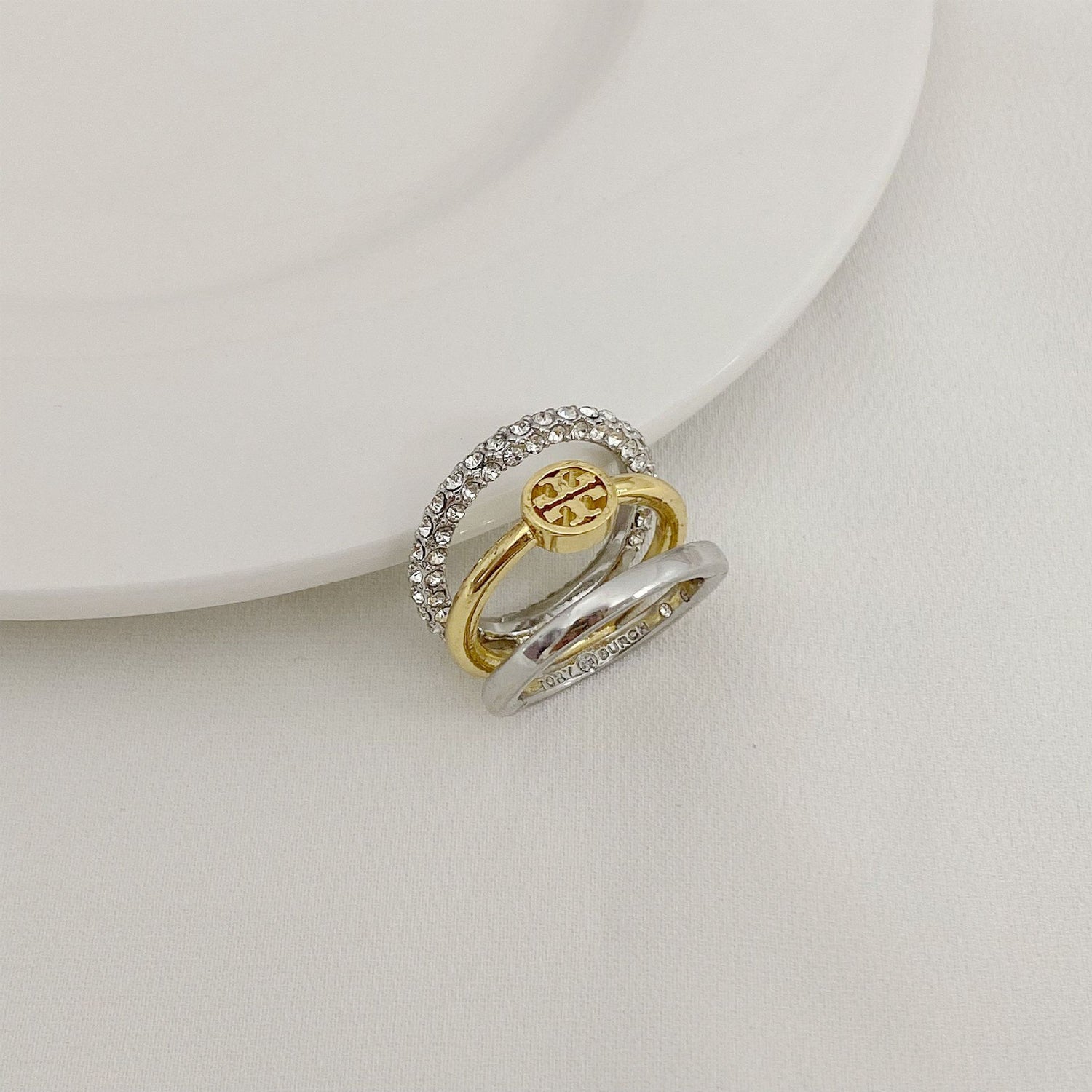 Two-tone three-band metal ring: gold interior, silver pavé outer band
