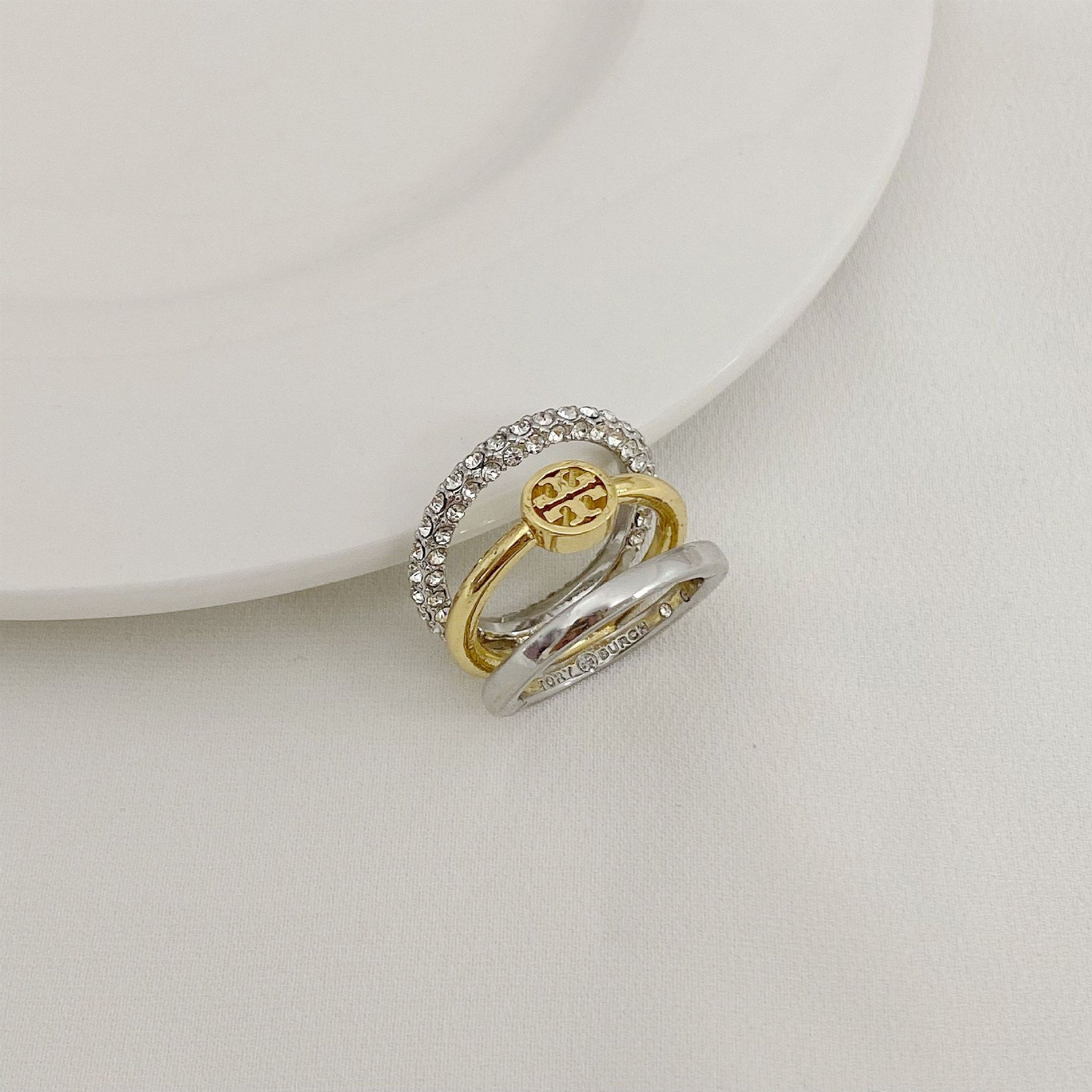 Two-tone three-band metal ring: gold interior, silver pavé outer band