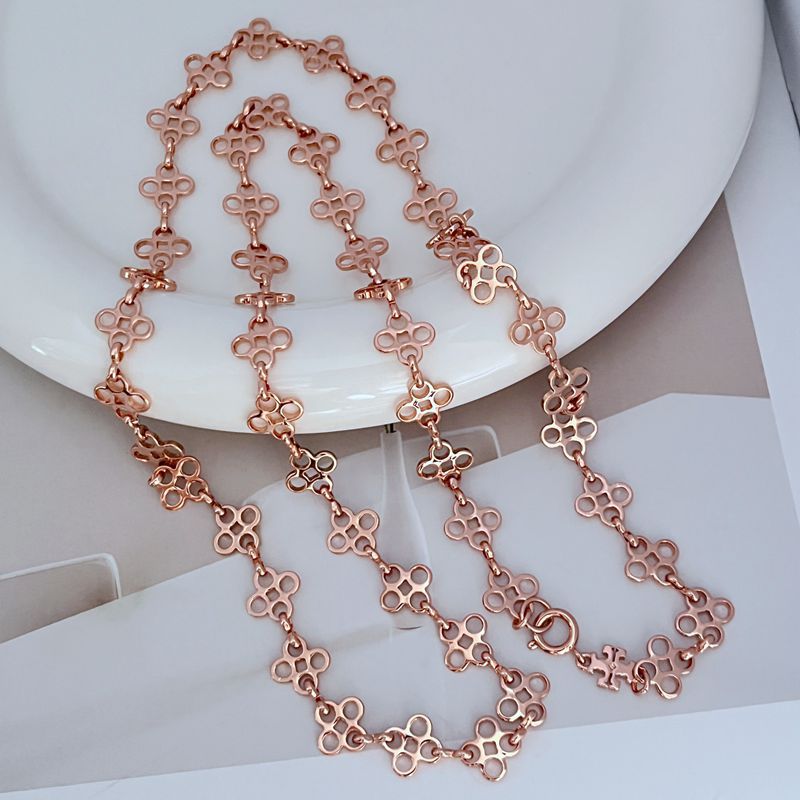 Rose gold four-leaf clover sweater chain with linked clover charms and clasp