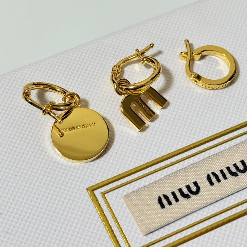Three-piece enamel hoop earrings with gold round charm and gold-tone metal hoops