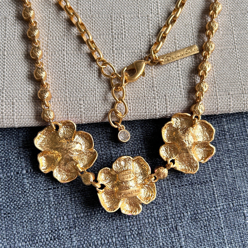 Enamel cherry blossom pendant necklace with gold-tone chain and flower charms