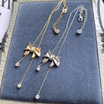 Bow crystal tassel necklace pair, gold-tone and silver-tone with round crystal drops
